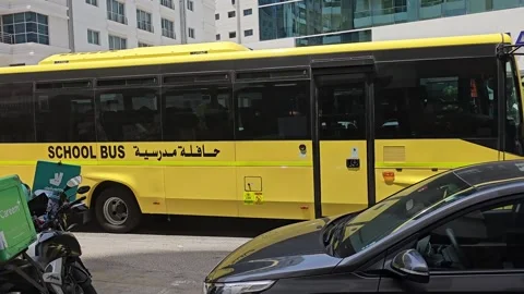 A vibrant yellow school bus, adorned with SCHOOL BUS Stock Footage 312003181