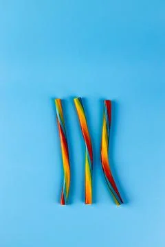 Vibrantly Colored Candy Twists on a Bright Blue Background: A Colorful Treat for Stock Photos