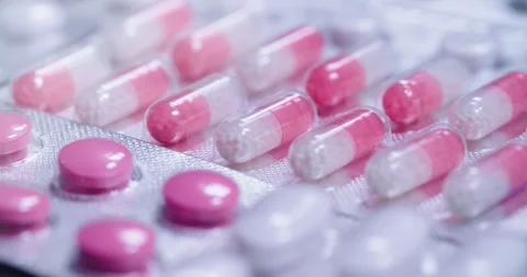 Vibrantly colored Capsules and Pills arranged in Blister Pack Stock Footage 302901490