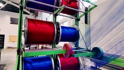Vibrantly Colored Textile Spools Present in a StateoftheArt Production Facility Stock Footage 323611129