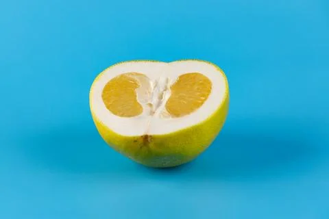 Vibrantly Cut Citrus Fruit on Bright Blue Background Showcasing Exquisite Stock Photos