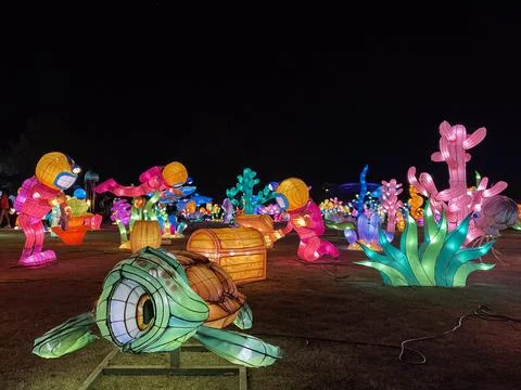 Vibrantly lit objects create nighttime fantasy world at park Foto stock