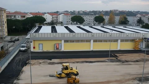 A vibrating compactor roller prepares the ground for asphalting. Stock-Footage 144401823