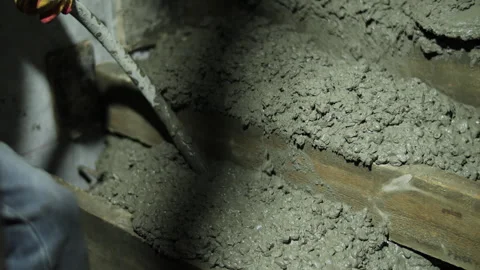 Vibrating fresh concrete during pouring at construction site Stock Footage 323433642