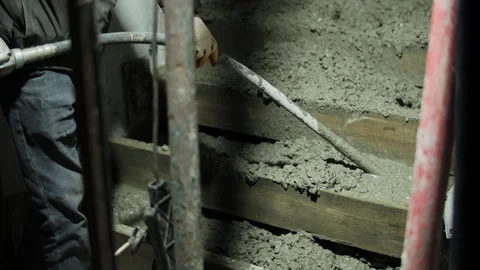 Vibrating fresh concrete inside formwork during wall pouring Stock Footage 323433425