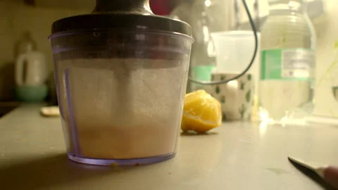 Vibrating motor processes butter in warm yellow lighting atmosphere Видео 333899747