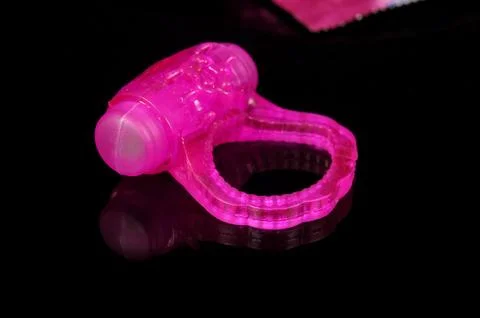 Vibrating penis ring isolated on the black background Stock Photos