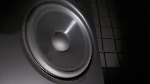 Vibrating Subwoofer Speaker Cone Pumping Loud Bass in Dark Studio Stock Footage 339208066