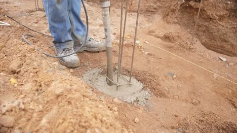 Vibration method for concrete settling and air release, handheld vibrator Stock Footage 319692147