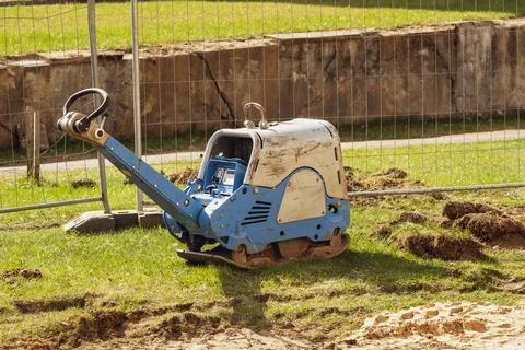 Vibratory plate compactor in construction site Stock Photos