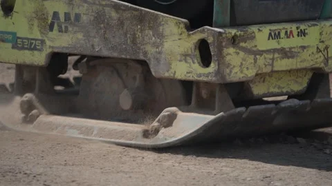 Vibratory Plate Compactor Flattening Dusty Ground on Construction Site Stockbeeldmateriaal 336449779