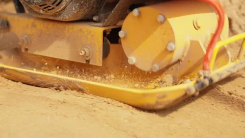 Vibratory plate compactor machine compacting sand Stock Footage 341294778