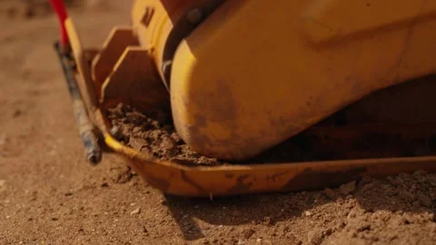 Vibratory plate compactor machine compacting soil Stock Footage 341294862