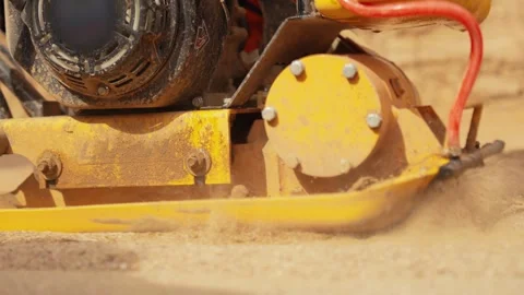 Vibratory plate compactor machine working on sand Stock Footage 341294855