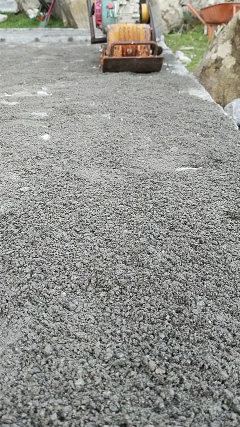 Vibratory plate compactor tamping fresh gravel Stock-Footage 329615337