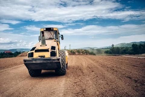 Vibratory Soil Compactor during highway building. Industrial roadworks Stock Photos