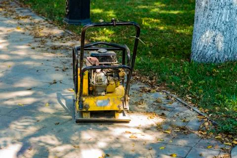 Vibro stacker of paving slab on the path in the park. Stock Photos