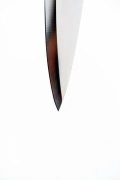 Vicious silver sharp metal blade of a kitchen chopping or carving knife with  Stock Photos