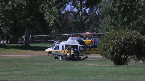 VICTIM LOADED INTO HELICOPT Stock Footage 22952408