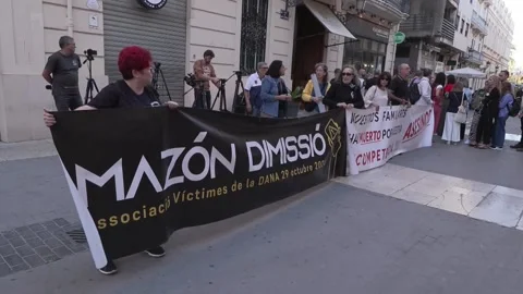 Victims of the storm gather in front of Les Corts shouting "Mazón resign!", Vale Stock Footage 317619472