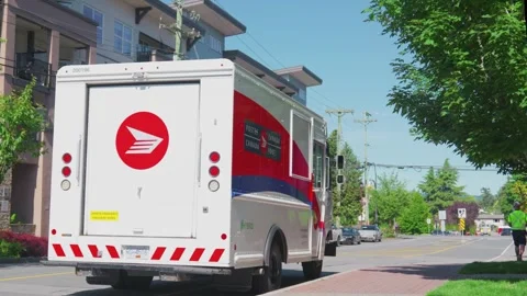 Victoria, BC, Canada - Aug 8, 2026: Canada Post hybrid mail truck on delivery Video stock 341801449