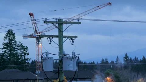 Victoria, BC, Canada: November 20, 2025 - Construction crane and utility pole Video stock 321506953