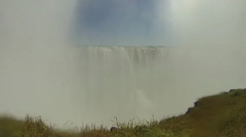 Victoria Falls appears between clouds of mist Stock Footage 22847567