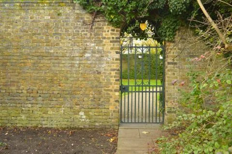 Victorian cast iron gate between brick walls Stock Photos