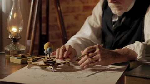 Victorian era astronomer using an orrery to predict a eclipse Stock Footage 270440155