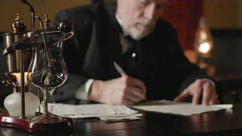 Victorian era businessman writing using a dip pen, focus on fancy coffee maker Stock Footage 334683365