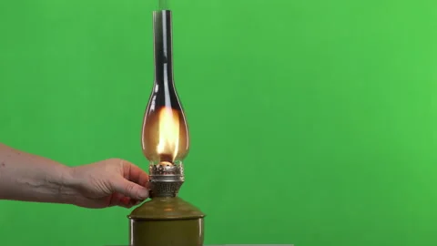 Victorian kerosene lantern on green screen. Adjusting an oil lamp gas wick flame Stock Footage 148606038