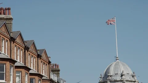 Victorian rooftops and Union Jack in London Stock Footage 90077244