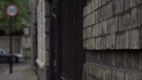 Victorian wall and gate on rainy London sidestreet Stock Footage 90107095