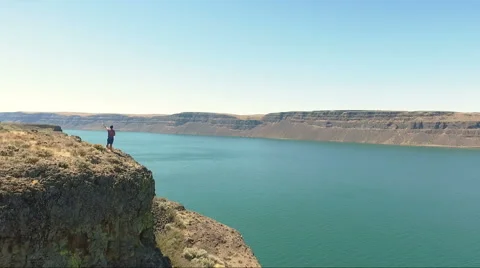 Victorious man on a cliff Stock Footage 65968130