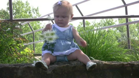 Vid016 he loves me he loves me not baby with flower Stock Footage