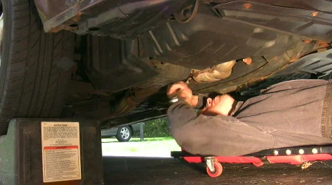 Vid027 working on car rolling out 스톡 동영상 486924