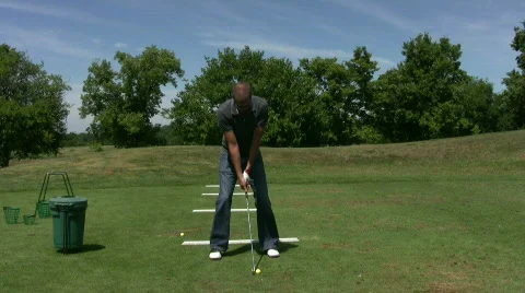 Vid043 young man golfing at range Stock Footage 493429