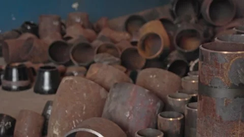 Video 4k. A diverse collection of rusty and worn metal pipes and fittings Stock Footage 284244610