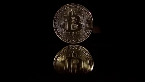 Video in 4k resolution bitcoin coin on a black background. Playing with light. Stock Footage 85907631