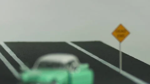 Video of a abandoned, light blue, retro car figurine left in the middle of a  Stock Footage 133491237