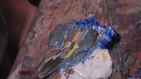 Video about mixing some multicolored paints with spatula. oil painting Stock Footage 201388971
