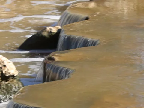 Video about small waterfalls in a lake with a heron Stock Footage 145368104