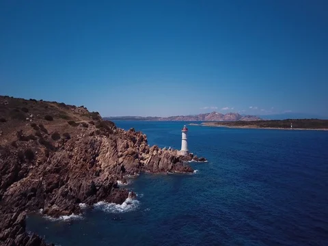 Video from above. Aerial view of a turquoise beach and a beautiful lighthouse Stock Footage