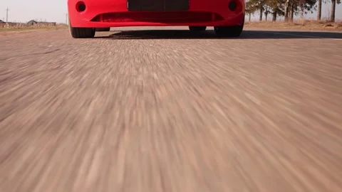 Video accelerated effect, shooting in motion, a red car rides on the road Stock Footage 131392250