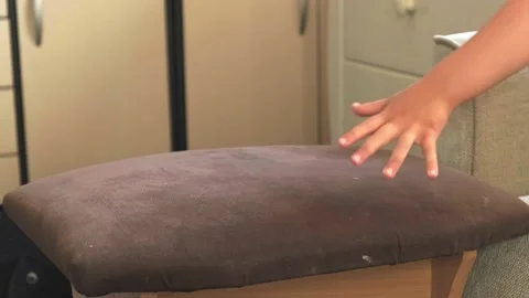 Video. The active boy had climbed on the chair and then on the couch, lying on Stock Footage 162791061