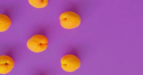 Video of Apricots pattern on bright purple background. Apricot pattern. Top view Stock Footage 271311119