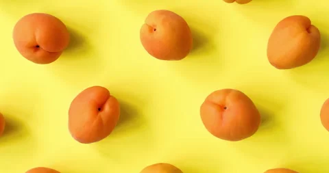 Video of Apricots pattern on yellow background. Apricot pattern. Top view, flat Stock Footage 301715872