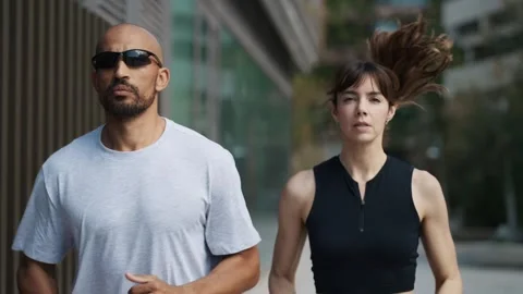 Video of athletic couple running through the city Stock Footage 300771213