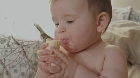 Video of a baby eating a piece of Stock Video Pond5