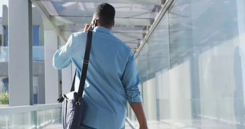 Video of back view of african american man walking and using smartphone Stock Footage 338325062